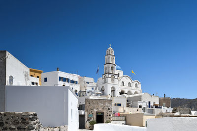 Buildings against clear blue sky