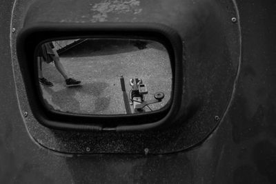 Low section of girl reflecting on mirror while walking at road