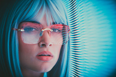 Portrait of young woman standing against abstract backgrounds