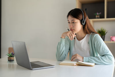Young businesswoman working at table