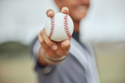 Midsection of man playing baseball