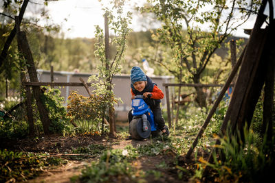 Side view of boy standing in park