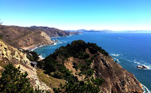 High angle view of sea and mountains against clear sky