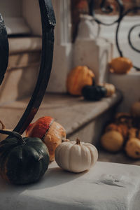 Variety of different kinds of pumpkins and squashes on the doorstep of a house, halloween decor.
