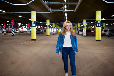 Portrait of woman standing in basement