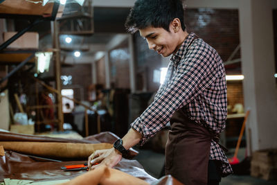 Side view of young man working at home