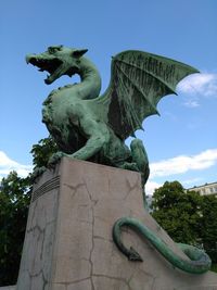 Low angle view of statue against blue sky