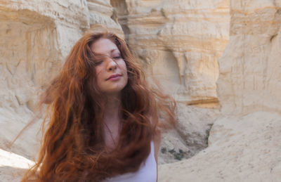 Red haired woman in windy canyon