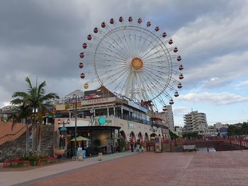 Ferris wheel in city against sky