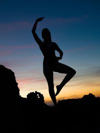 Silhouette woman doing yoga against sky during sunset