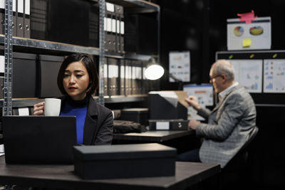 Businesswoman using laptop at office