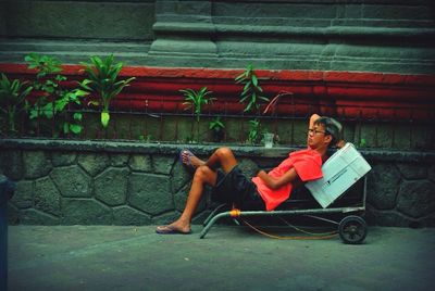 Woman sitting on wall