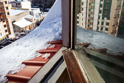 High angle view of snow covered buildings in city