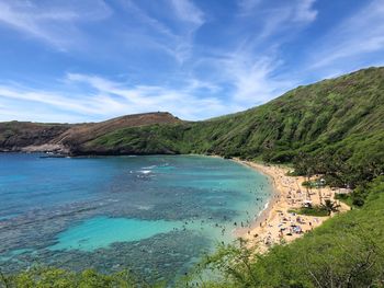 Scenic view of sea and mountains against sky