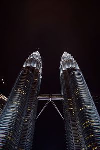 Low angle view of illuminated building against sky at night