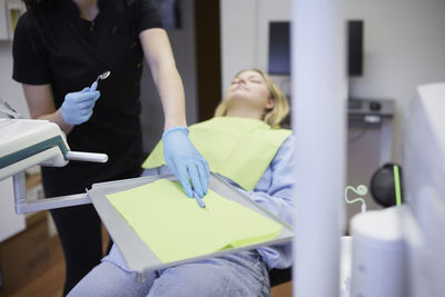 Female dentist with patient in office