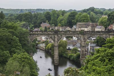 Railway bridge over river amidst trees at knaresborough