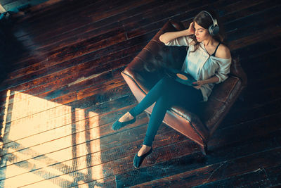 Portrait of young woman sitting on staircase