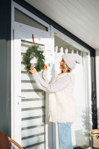 Young woman standing by window