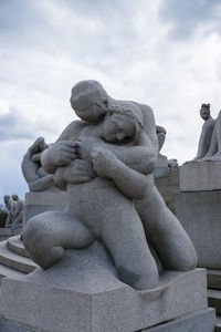 Low angle view of statue of two people embracing