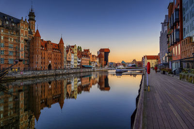 Reflection of old town in motlawa river at sunrise