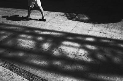 Low section of woman standing on tiled floor