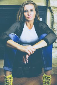 Portrait of young woman sitting outdoors