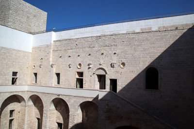 Low angle view of old building against blue sky