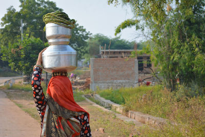 Woman carrying containers on head