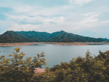 Scenic view of lake and mountains against sky