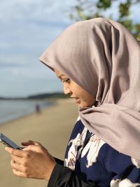 Side view of man using mobile phone