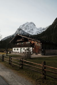 Houses by mountain against clear sky