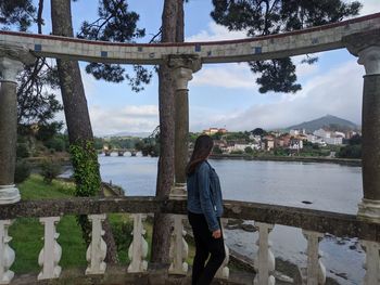 Rear view of woman standing on bridge