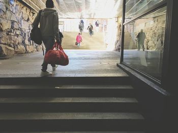 Rear view of women walking on staircase