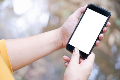 Close-up of hand holding mobile phone