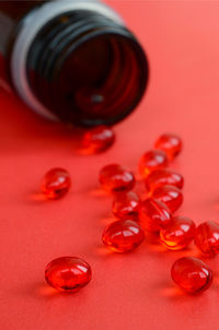 High angle view of capsules on red background