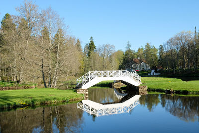 Arch bridge over lake against sky