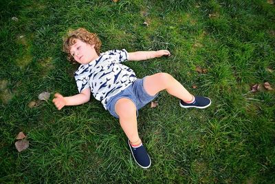 Directly above shot of boy lying on grass