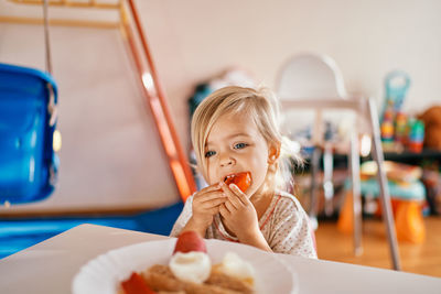 Portrait of cute girl eating food