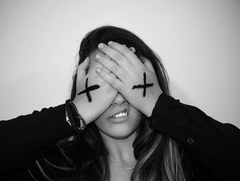 Portrait of young woman against white background