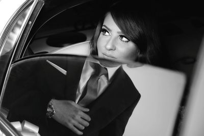 Portrait of woman looking through car window