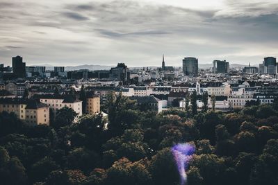 Cityscape against cloudy sky