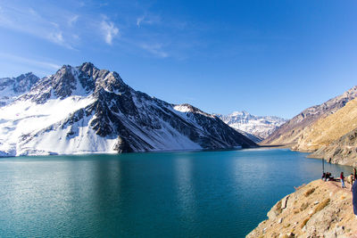 Scenic view of lake and snowcapped mountains against sky