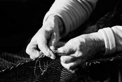 Close-up of person weaving textile