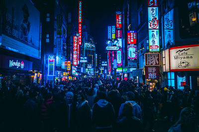 Crowd at illuminated city at night