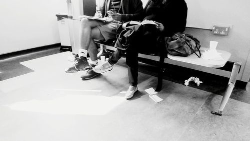 Low section of people sitting on table