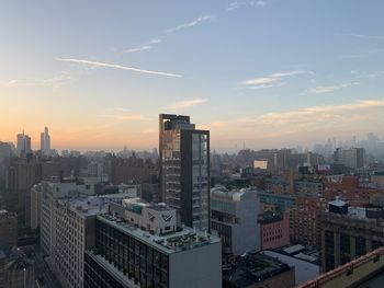 High angle view of buildings in city against sky during sunset