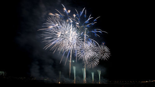 Low angle view of firework display at night