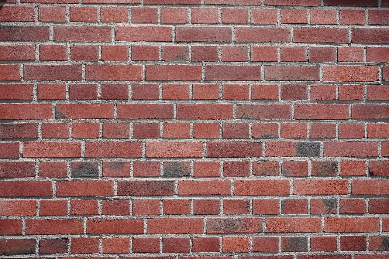 FULL FRAME SHOT OF BRICK WALL AGAINST STONE WALLS