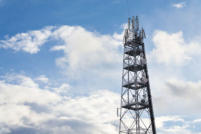 Low angle view of communications tower against sky